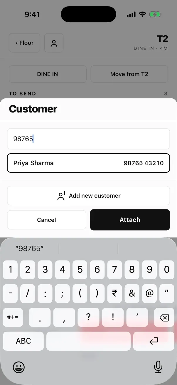 iPhone pe EasyKOT captain app, peeche table T2 dim, upar Customer sheet: search box mein 98765 type kiya hua, ek match Priya Sharma 98765 43210 outline mein, Add new customer, Cancel aur Attach buttons, aur sheet ke neeche phone ka keyboard